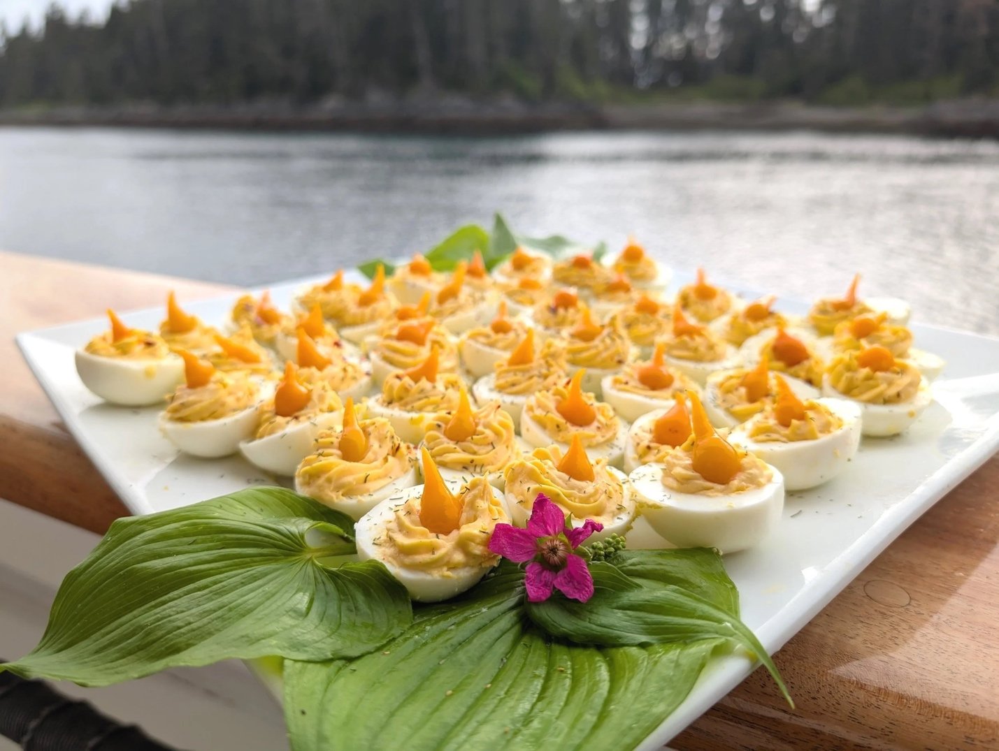 “Deer Heart” leaves displayed as layered garnishes on a plate of April’s Deviled Eggs