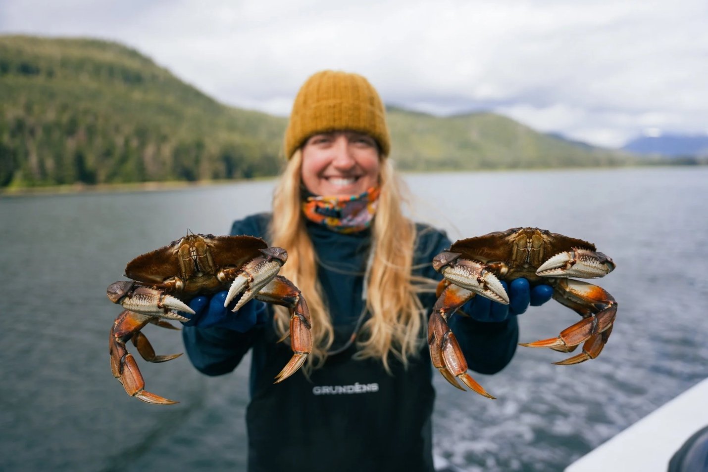 Crew aboard one of the M/V Liseron’s skiff boats display passengers’ fresh and sustainably caught crab